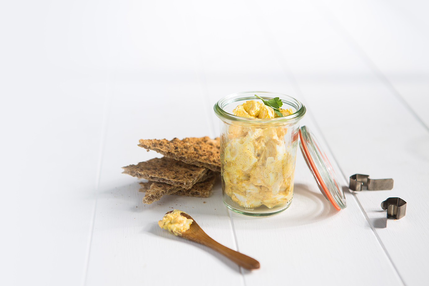 Image of curried eggs in a jar with Ryvita triangles.
