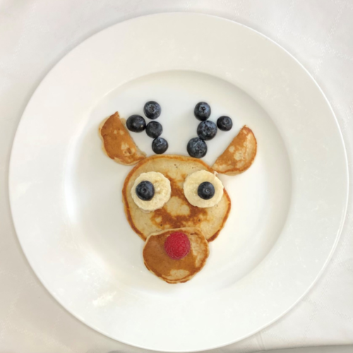 reindeer head made from pikelets, sliced banana, blueberries and raspberries