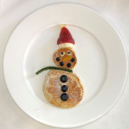 snowman made from pikelets, blueberries, sliced banana and strawberries