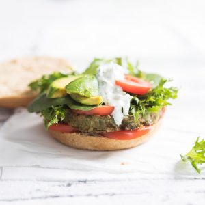 Image of an open lentil burger serving on a white cutting board