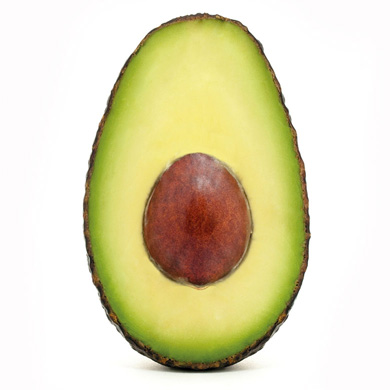 Image of half an avocado on a plain white background