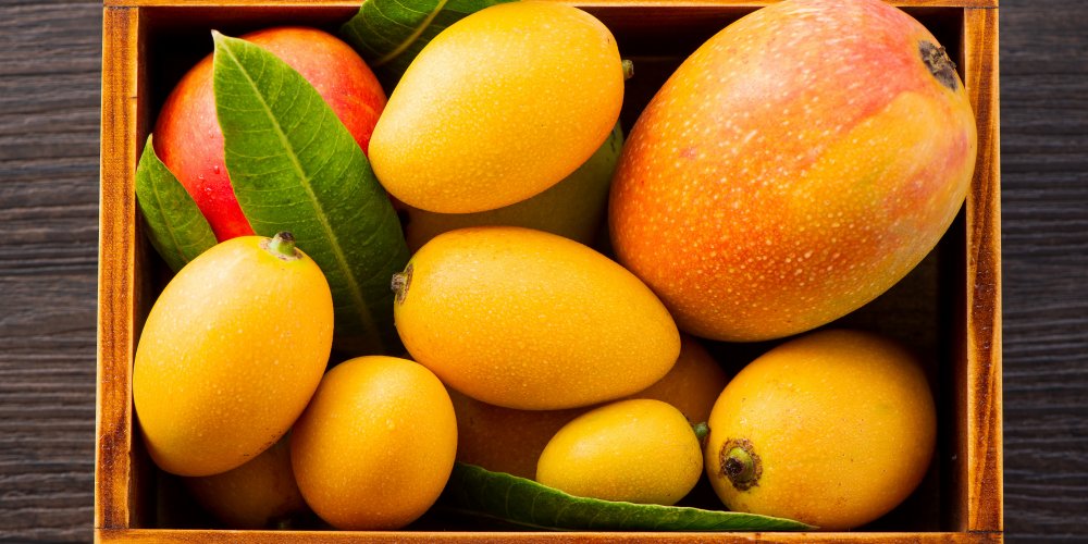 Wooden box containing 8 mangoes